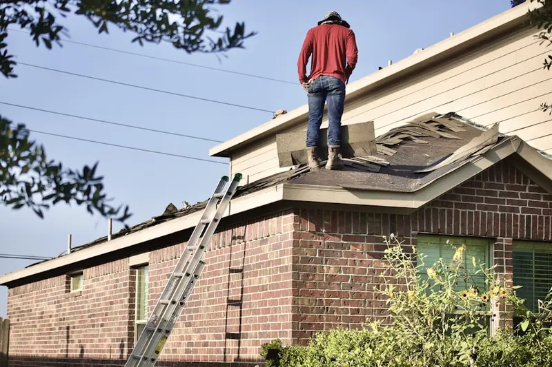 Professional roofer working on a residential roof in Agnewville